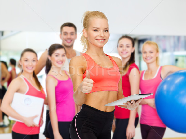 smiling sporty woman with tablet pc computer Stock photo © dolgachov
