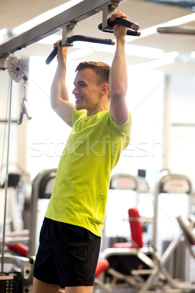 smiling man exercising in gym Stock photo © dolgachov