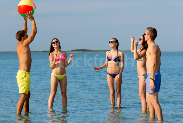 smiling friends in sunglasses on summer beach Stock photo © dolgachov