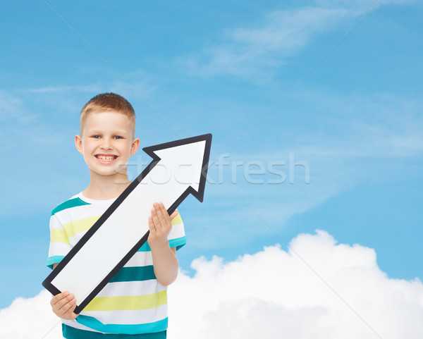 smiling little boy with blank arrow pointing right Stock photo © dolgachov