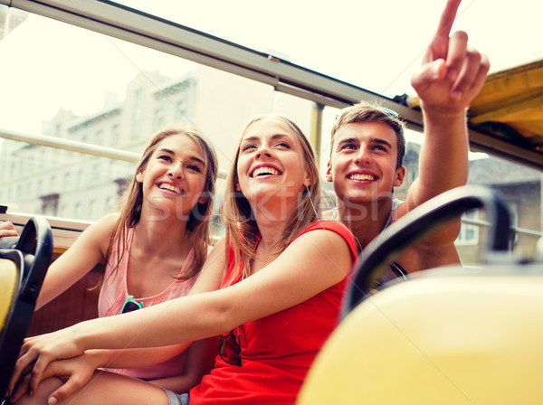 group of smiling friends traveling by tour bus Stock photo © dolgachov