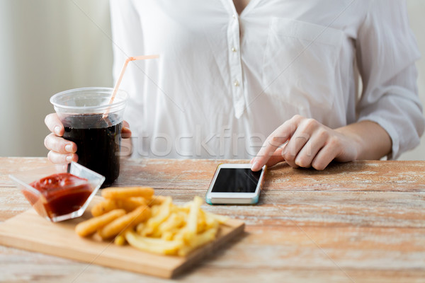 close up of woman with smart phone and fast food Stock photo © dolgachov