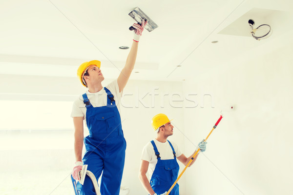 group of builders with tools indoors Stock photo © dolgachov