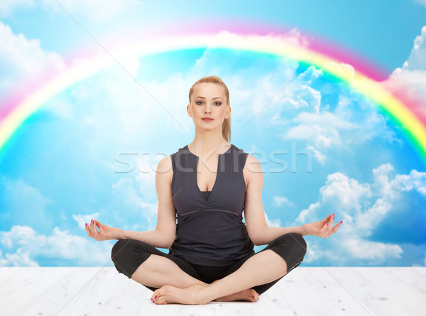 happy young woman meditating in yoga lotus pose Stock photo © dolgachov