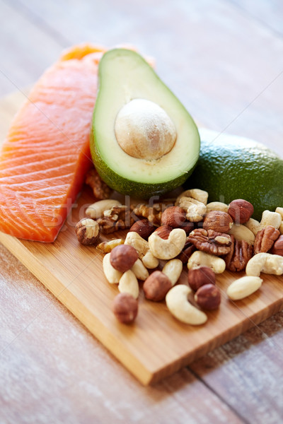 close up of salmon, avocado and nuts on table Stock photo © dolgachov