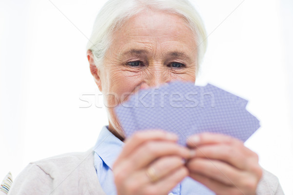 close up of happy senior woman playing cards Stock photo © dolgachov