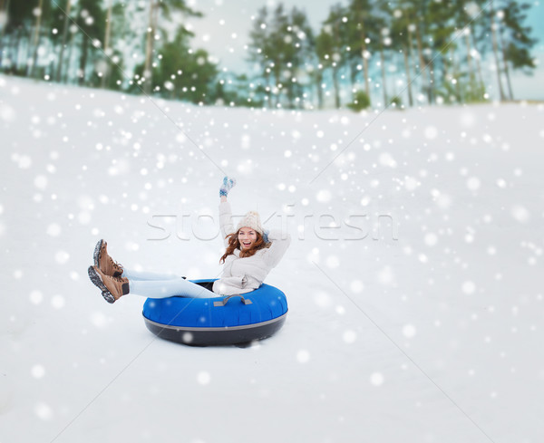 happy teenage girl sliding down on snow tube Stock photo © dolgachov