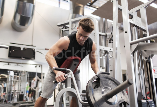 Jonge man rij machine gymnasium sport Stockfoto © dolgachov