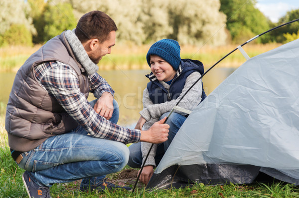 happy father and son setting up tent outdoors Stock photo © dolgachov