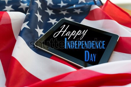close up of tablet pc computer on american flag Stock photo © dolgachov