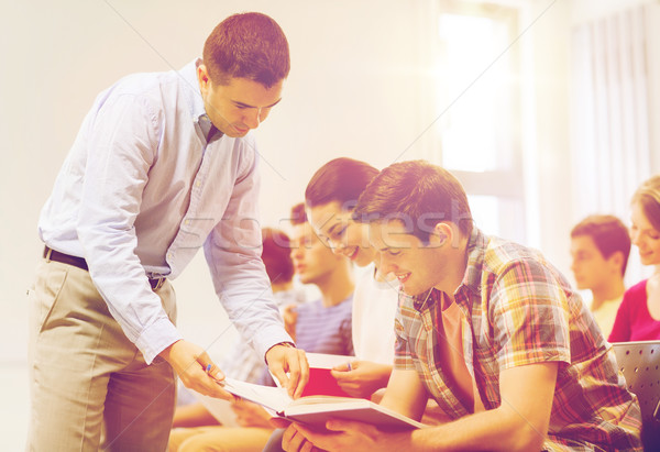 group of students and teacher with notebook Stock photo © dolgachov