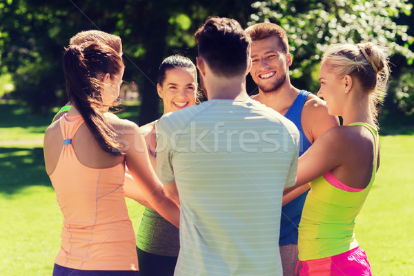 group of happy friends with hands on top outdoors Stock photo © dolgachov