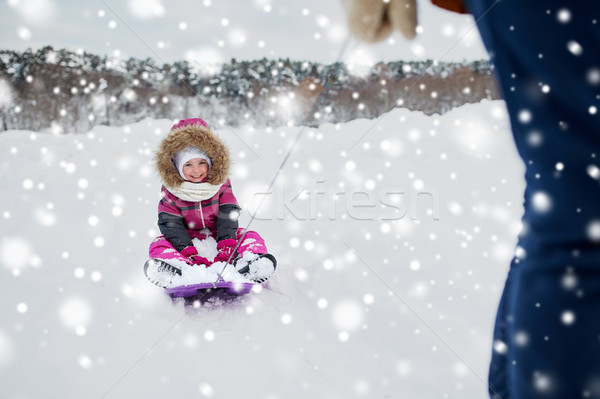 parent carrying happy little kid on sled in winter Stock photo © dolgachov