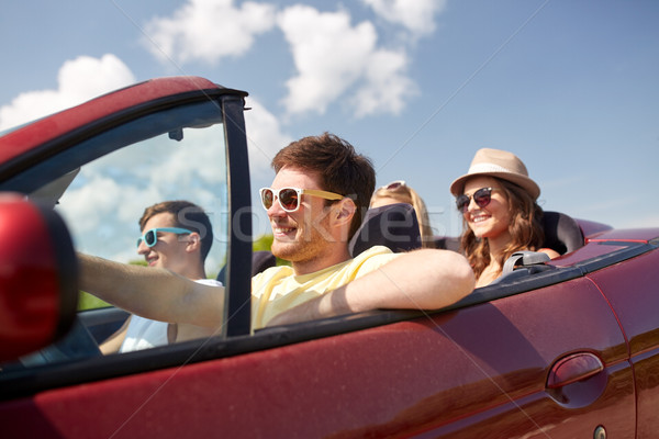 happy friends driving in cabriolet car Stock photo © dolgachov