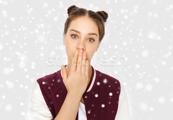 confused teenage girl covering her mouth by hand Stock photo © dolgachov