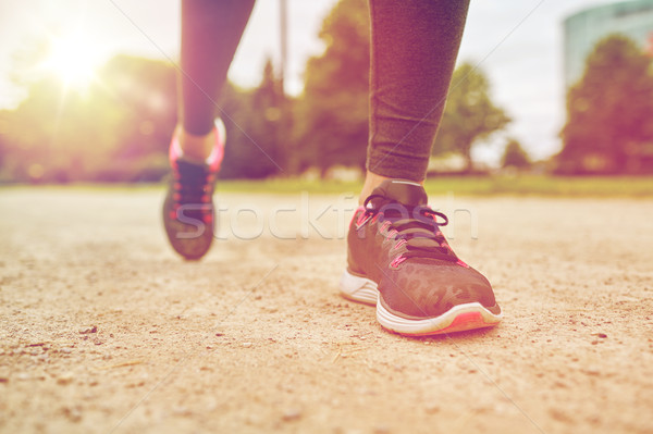 close up of woman feet running on track from back Stock photo © dolgachov