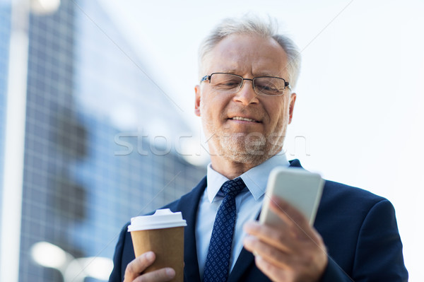 businessman with smartphone and coffee in city Stock photo © dolgachov