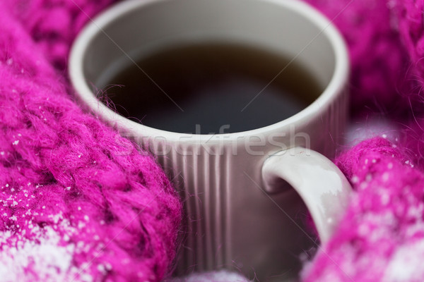 Close Up Of Tea Or Coffee And Winter Scarf In Snow Stock Photo