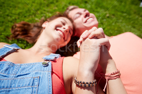 happy teenage couple lying on grass at summer Stock photo © dolgachov