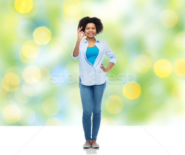 happy african american woman showing ok hand sign Stock photo © dolgachov