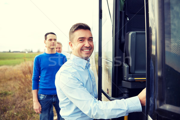 group of happy male passengers boarding travel bus Stock photo © dolgachov