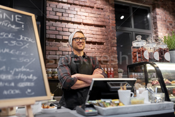 happy seller man or barman at cafe counter Stock photo © dolgachov