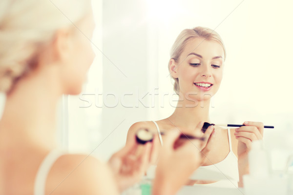 woman with makeup brush and eyeshade at bathroom Stock photo © dolgachov