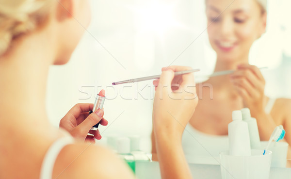 woman with lipstick and make up brush at bathroom Stock photo © dolgachov