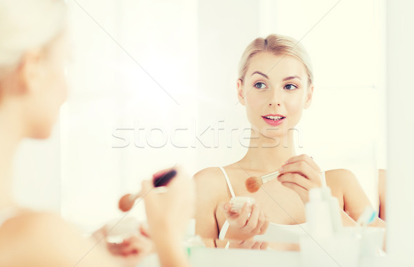 Stock photo: woman with makeup brush and powder at bathroom