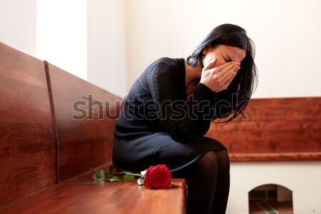 woman with coffin crying at funeral in church Stock photo © dolgachov