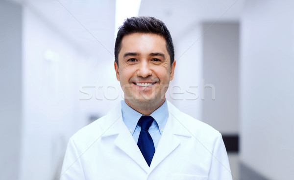 Stock photo: smiling doctor in white coat at hospital