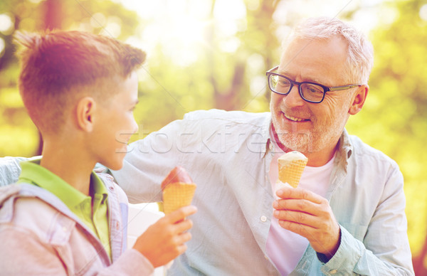 old man and boy eating ice cream at summer park Stock photo © dolgachov