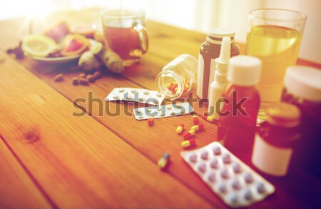 woman pouring medication from bottle to spoon Stock photo © dolgachov