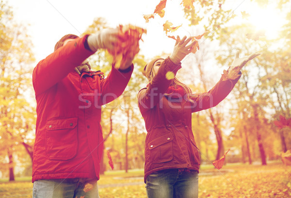 happy young couple throwing autumn leaves in park Stock photo © dolgachov
