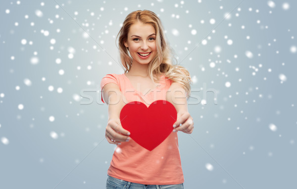 Stock photo: happy woman or teen girl with red heart shape