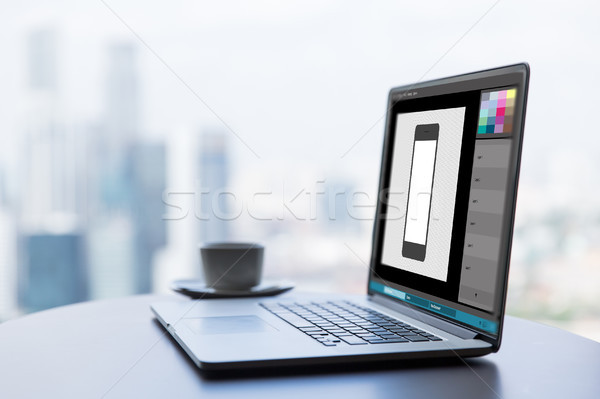 laptop with smartphone image in graphics editor Stock photo © dolgachov
