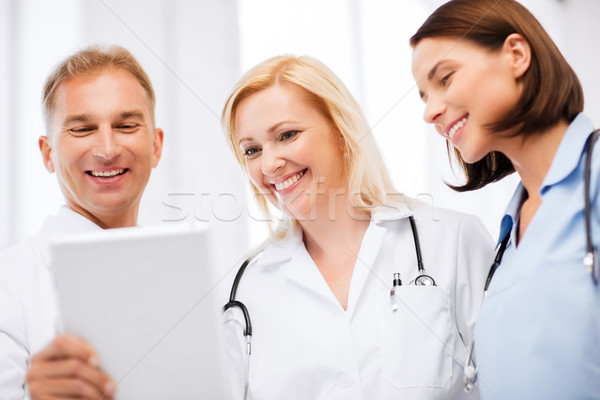 doctors looking at tablet pc Stock photo © dolgachov