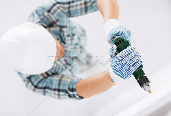 Férfi fúrás fal belsőépítészet otthon rendbehoz Stock fotó © dolgachov