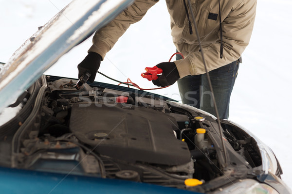 closeup of man under bonnet with starter cables Stock photo © dolgachov