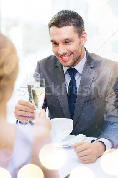 Stock photo: couple with glasses of champagne at restaurant