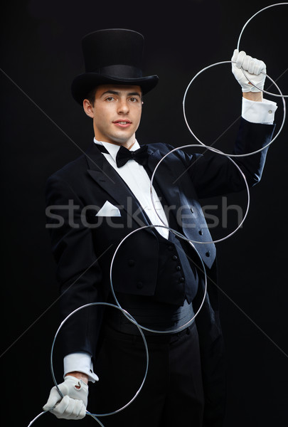 magician showing trick with linking rings Stock photo © dolgachov