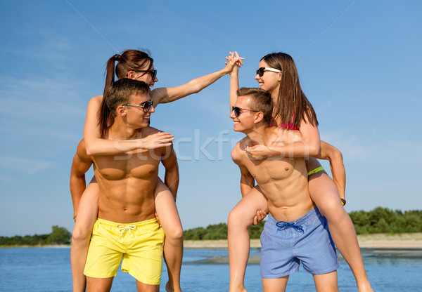 Stock photo: smiling friends in sunglasses on summer beach