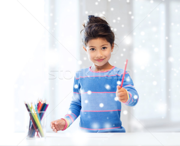 smiling little girl with pencils drawing at home Stock photo © dolgachov