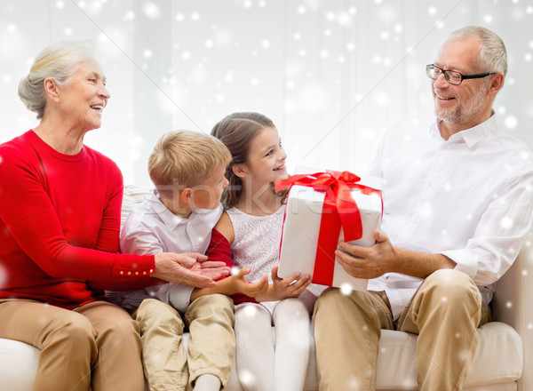 smiling grandparents and grandchildren with gift Stock photo © dolgachov