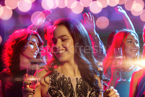 Sonriendo amigos gafas champán club fiesta Foto stock © dolgachov
