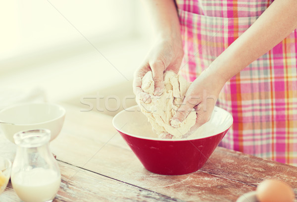 close up of female hands kneading dough at home Stock photo © dolgachov
