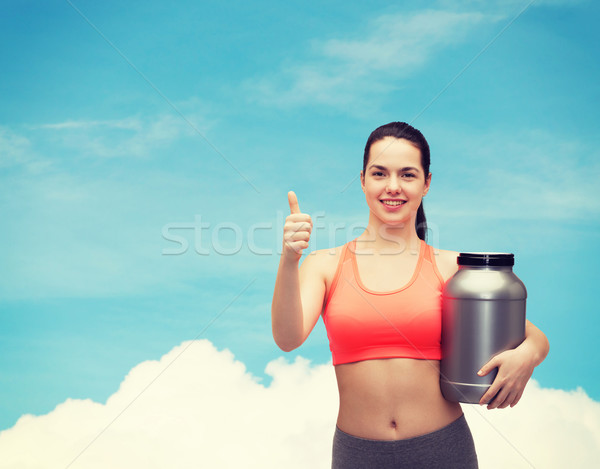 teenage girl with jar of protein showing thumbs up Stock photo © dolgachov