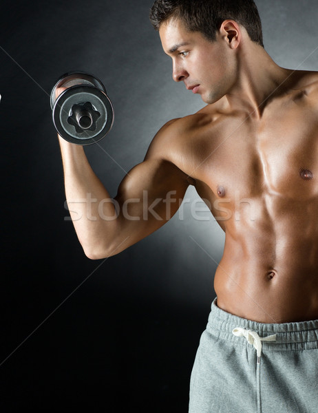 young man with dumbbell Stock photo © dolgachov