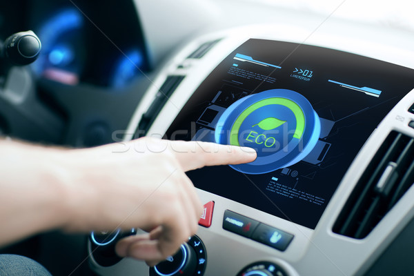 male hand setting car eco system mode on screen Stock photo © dolgachov