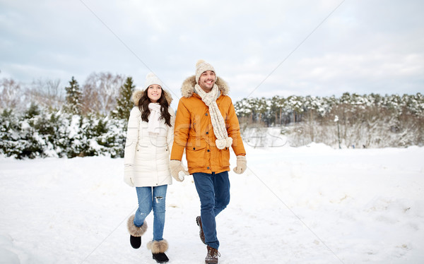 Stock photo: happy couple walking along snowy winter field